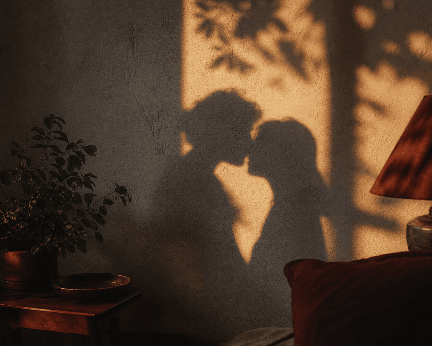 Warm shadows of two people leaning close on a wall